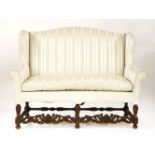 A Carolean-style walnut wing backed two-seat settee, with cream striped upholstery over turned and