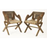 A pair of oak Glastonbury chairs, 19th century 'Gothic Revival', carved with foliage, a crown of