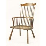 A primitive ash and elm Windsor chair,18th century, with a shaped top rail, remnants of paint