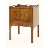 A George III mahogany pot cupboard,the tray top over two doors and a drawer,59cm wide58cm deep73cm