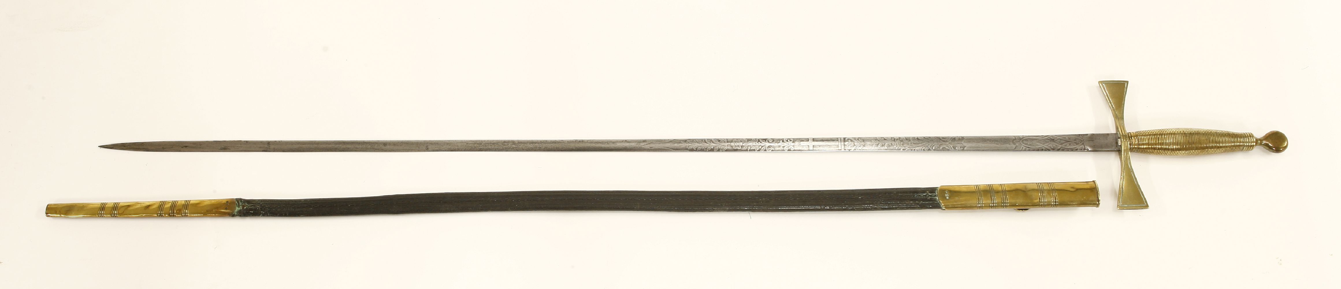 A brass hilt sword,with engraved blade, in a brass mounted black leather scabbard,sword 97.5cm (2)