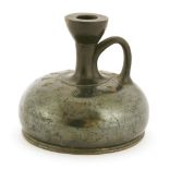 A Roman squat blackware terracotta bottle,with a lustrous body and incised with anthemia and husks