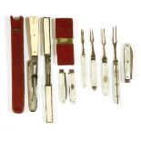 A Georgian silver and mother-of-pearl handled folding fruit knife and fork set, each with