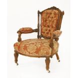 A Victorian walnut open armchair,the frame finely carved with leaves and foliage, with button