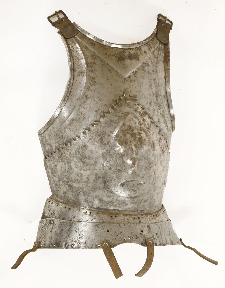 A Milanese breastplate,late 15th century, with prominent human mask to centre and two stamped