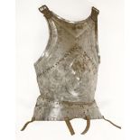 A Milanese breastplate,late 15th century, with prominent human mask to centre and two stamped