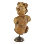 A carving of a putto,probably 18th century, carved waist high, 40cm high,53cm overall, on a later