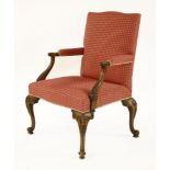 A George III-style mahogany library chair,with carved and scrolled arm supports and four carved