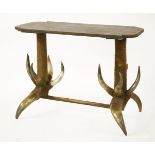 An unusual table,20th century, the shaped rectangular top, canvas mounted, raised on hair and horn