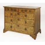 A Queen Anne walnut chest of drawers, with quarter veneered top, above two short and three long