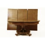 A William IV mahogany extending dining table, the top with rounded ends, on split pedestal and