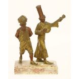 After Franz Xavier Bergmann,a cold painted bronze of two minstrels, mounted on a marble plinth,