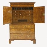 A Queen Anne walnut cabinet,the top section with a cushion moulded drawer over two doors,