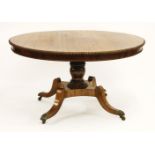 A Regency rosewood centre table, the circular top with a beaded edge on a faux rosewood turned