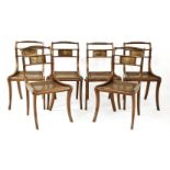 A set of six Regency mahogany single dining chairs,with spirally turned top rails, brass inlaid