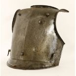 An iron breastplate, 17th century, with bullet dent 'proof',48cm high'Armour of proof' was known