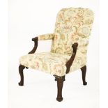 A mahogany Gainsborough armchair,with a shaped back and reeded arms over scrolled legs,