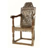 An oak armchair,late 17th century, the carved and scrolled top rail over a strapwork panelled