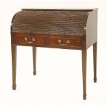 A George IV mahogany roll-top desk,enclosing stationery drawers, pigeonholes and a ratcheted green