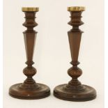 A pair of yew wood candlesticks, early 19th century, with brass nozzles, 27cm high (2)Provenance: