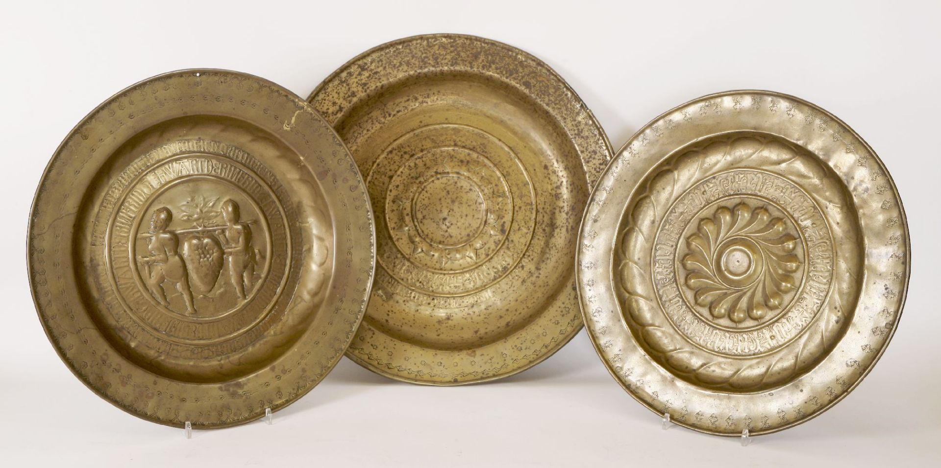 Three embossed brass Nuremberg alms dishes,42, 40.5 and 47cm, andanother,22.5cm diameter (4)
