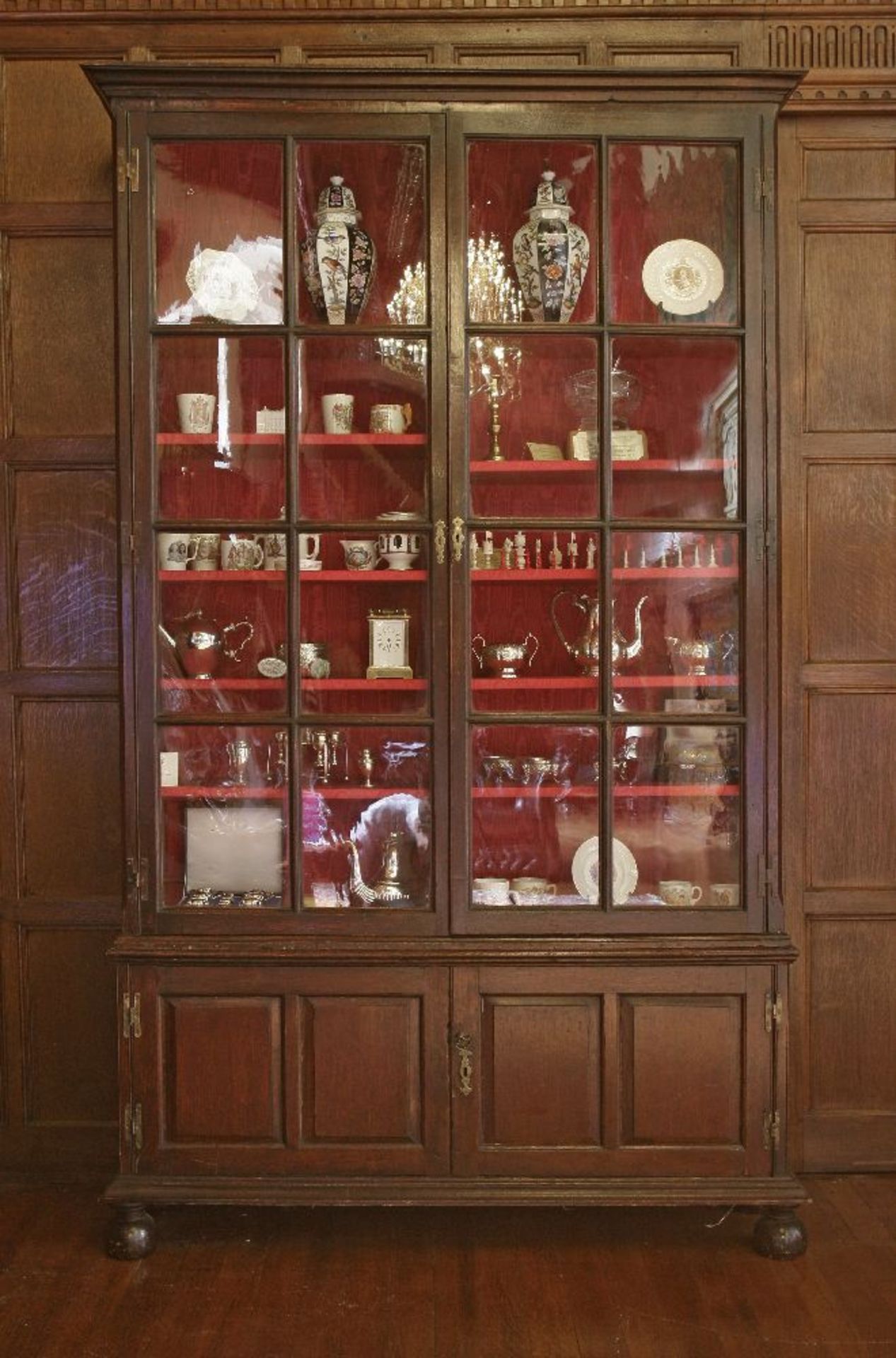 A George ll oak bookcase,the moulded cornice over two astragal glazed doors, two panelled doors