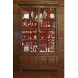 A George ll oak bookcase,the moulded cornice over two astragal glazed doors, two panelled doors