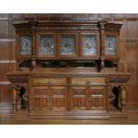 An extraordinary late Victorian oak sideboard,the raised back with a dentil and carved frieze over