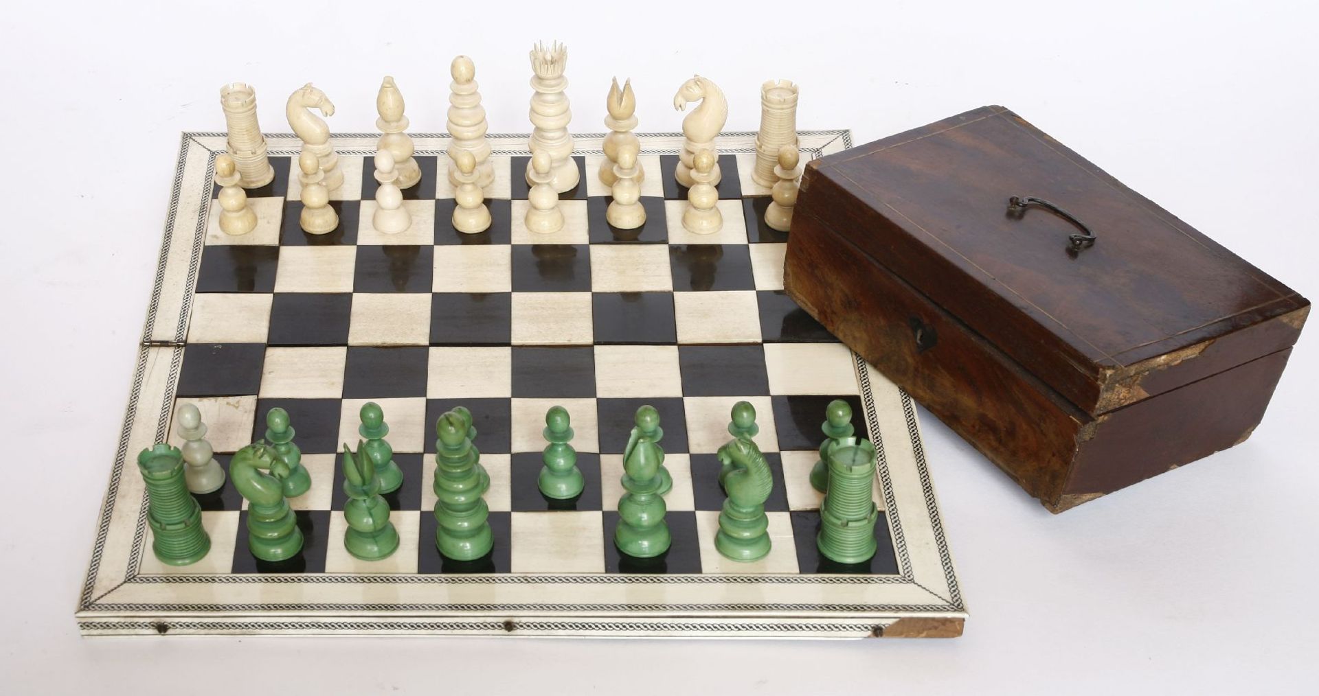A Chinese ivory chess set,mid-19th century, with engine turned and carved decoration, red stained - Image 2 of 2