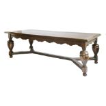 An oak refectory table,in the 17th century Dutch style, the cleated plank top over a wavy frieze,