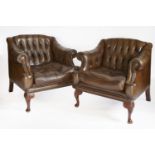 A pair of modern brown leather armchairs,with deep buttoned backs, seat cushions, studded arms and