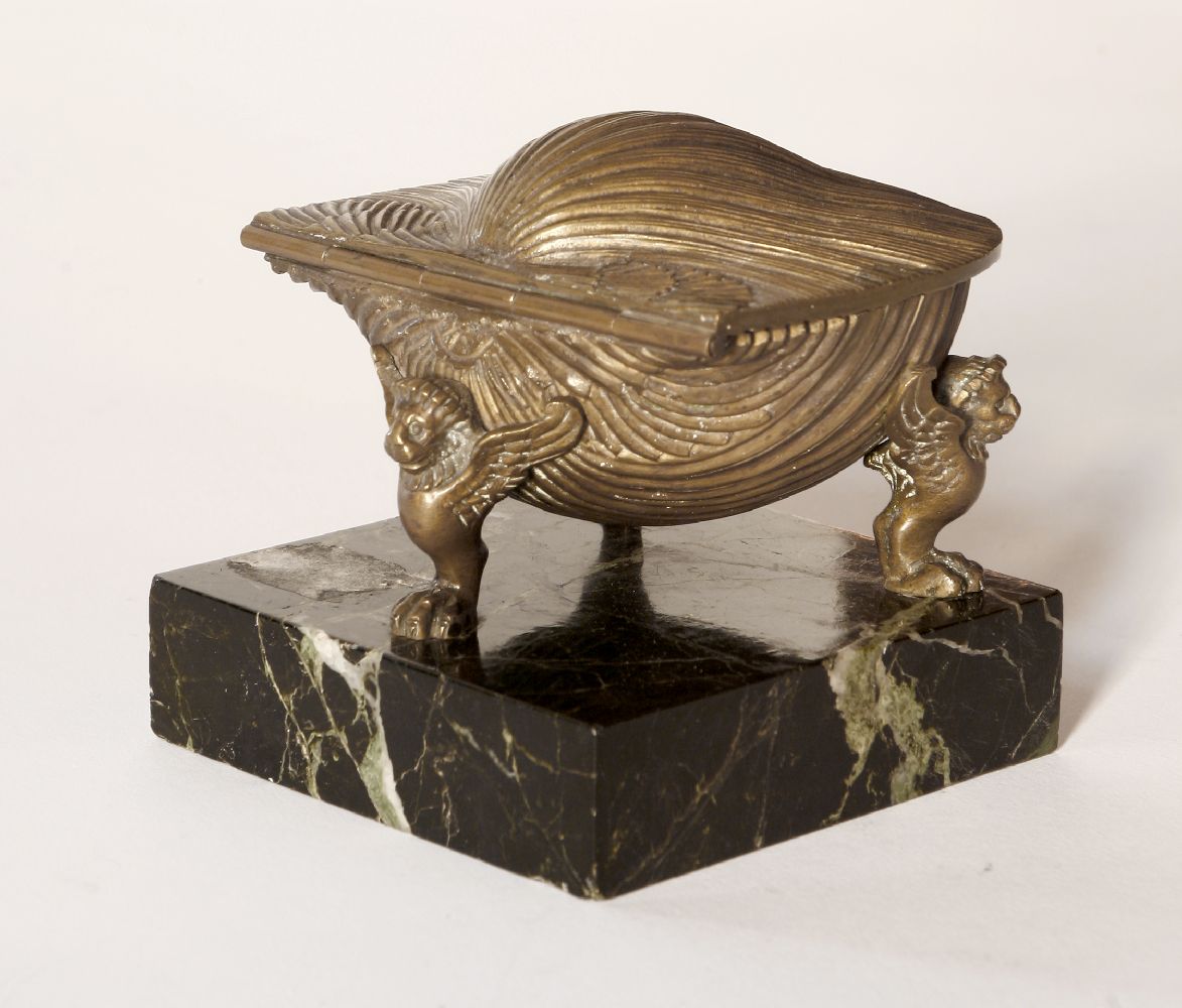 A brass desk inkwell,19th century, probably French, cast as an oyster shell, opening to reveal a