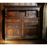 An inlaid oak buffet.17th century and later, the top section with egg and dart and arcaded moulding,