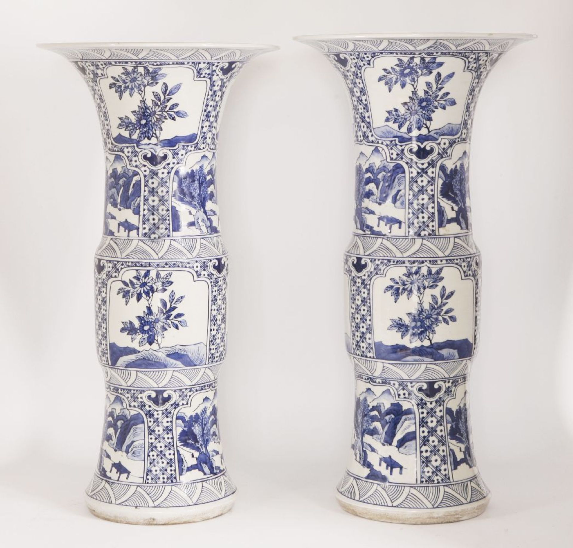 A pair of Chinese export ware blue and white gu form vases, 20th century, decorated all over with