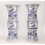 A pair of Chinese export ware blue and white gu form vases, 20th century, decorated all over with