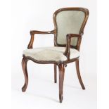 A Louis XVl-style mahogany elbow chair,early 20th century, the shaped padded back over moulded