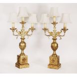 A pair of giltwood and cast metal, two-branch, three-light table lamps,20th century, with leaf-