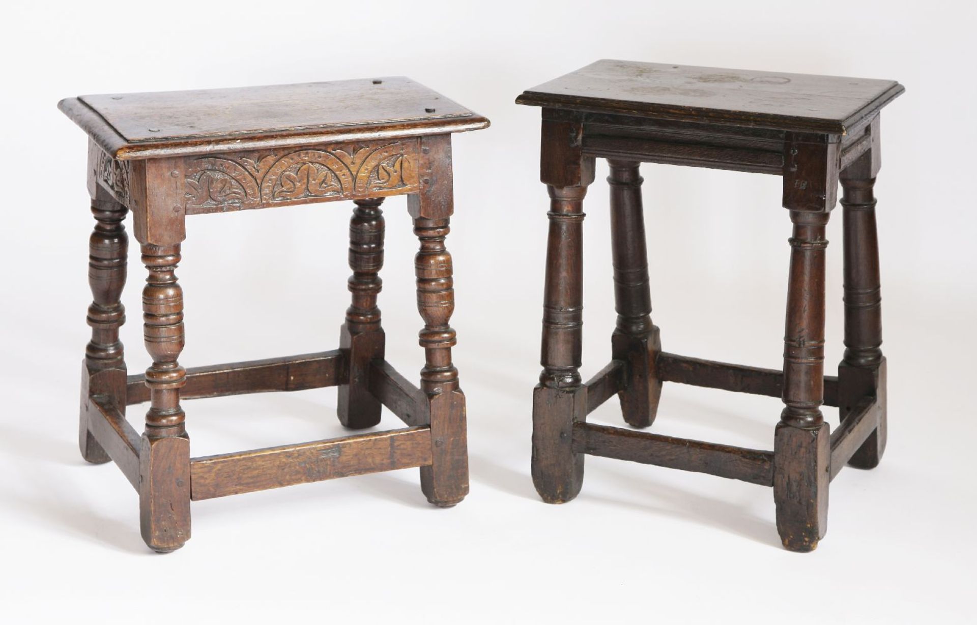 Two oak joined stools,17th century and later, one with a lunette carved frieze and one with a