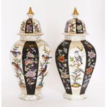 A pair of Meissen-style vases and covers,20th century, of octagonal panelled shape with high domed