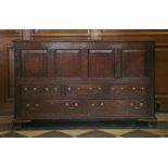 A four-panel oak mule chest,18th century, the rising lid above an arrangement of three small and two