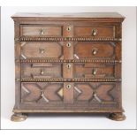 A Charles ll oak chest of drawers,having four long geometrically moulded drawers and panelled