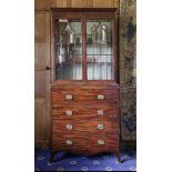 A George III mahogany and boxwood strung secretaire bookcase,the moulded cornice above two