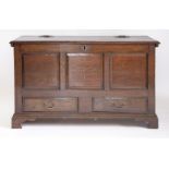 An oak mule chest,18th century, the hinged panelled top over three fielded panels, two drawers and