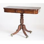 A Regency mahogany tea table,the fold-over top with a reeded border above a turned spiral twist