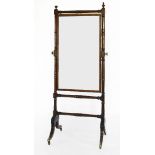 A Regency mahogany and ebony strung cheval mirror,within a turned frame with vase-shaped finials,