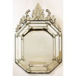 A Venetian glass wall mirror,19th century, with a decorative applied floral and leaf scrolled finial