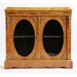 A French walnut side cabinet,19th century, having a cushion moulded top over two doors with oval