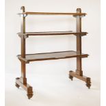 A Victorian mahogany three-tier dumb waiter,the rectangular end supports with carved arched