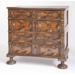 A William-and-Mary-style panelled and moulded chest,of four long drawers on raised bun feet, in