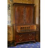 A George III mahogany secretaire cabinet,the moulded teardrop cornice above a two-door panelled